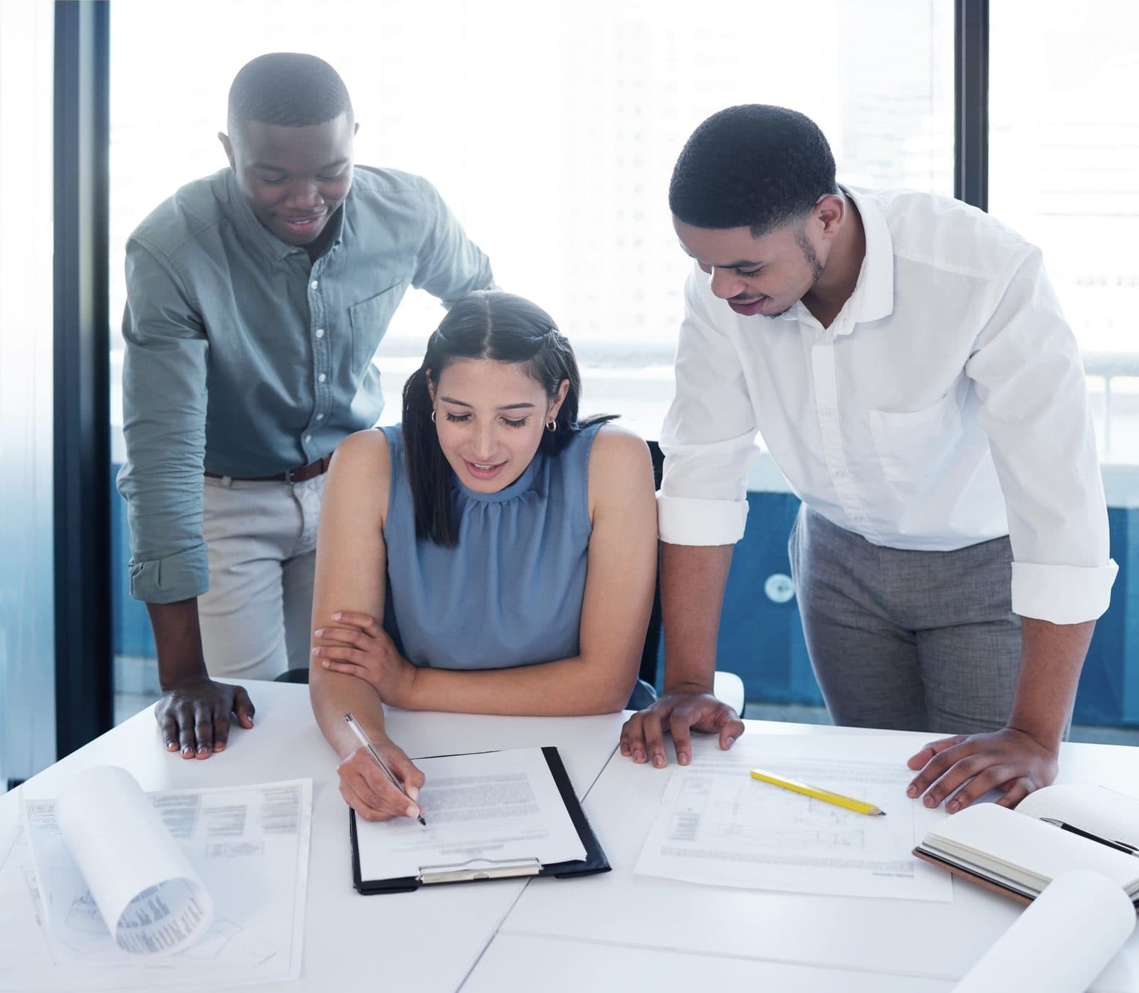 A team reviewing a blueprint at a meeting table