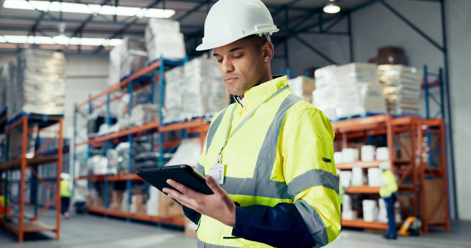 A warehouse worker checking stock on a tablet