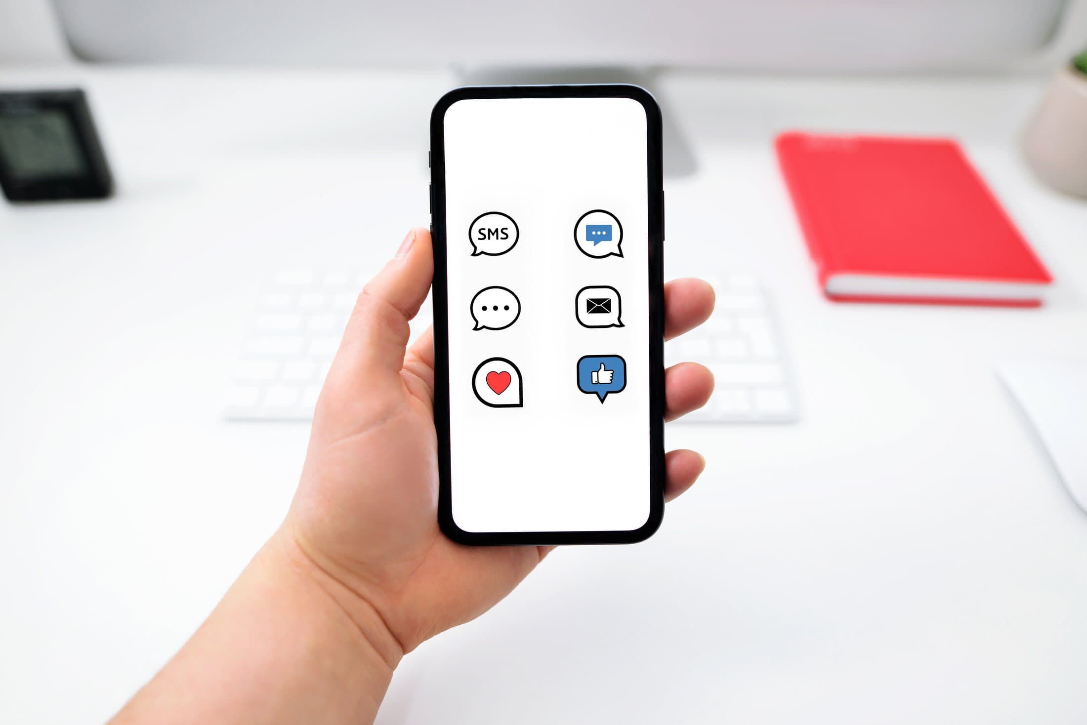 Hands holding a phone with a messaging app open